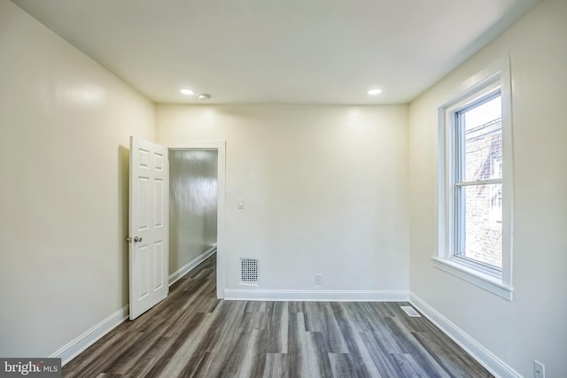 empty room with dark wood-type flooring