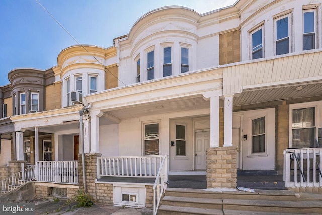 townhome / multi-family property featuring a porch