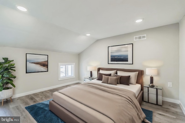 bedroom featuring vaulted ceiling and light hardwood / wood-style flooring