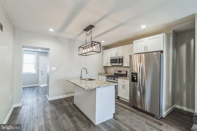 kitchen featuring a center island with sink, sink, appliances with stainless steel finishes, and white cabinets