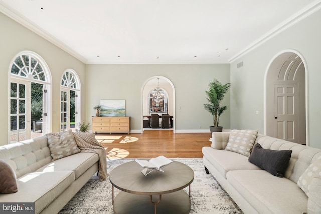 living room with ornamental molding and hardwood / wood-style floors