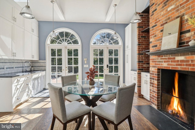 dining room featuring light wood-type flooring, sink, and french doors