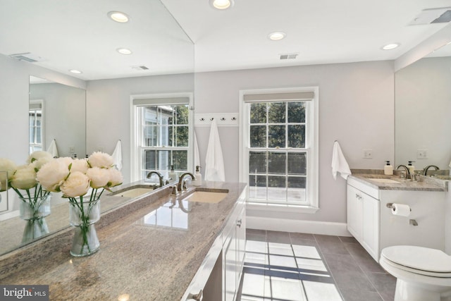 bathroom featuring vanity, tile patterned flooring, and toilet