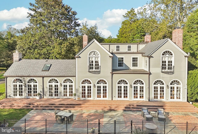 back of property with french doors and a patio