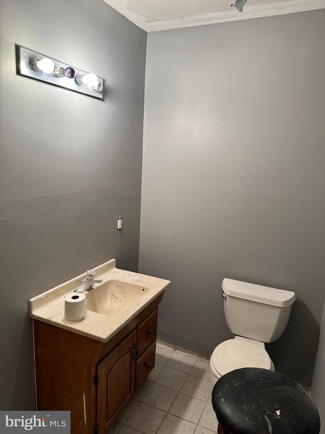 bathroom featuring vanity, toilet, ornamental molding, and tile patterned flooring