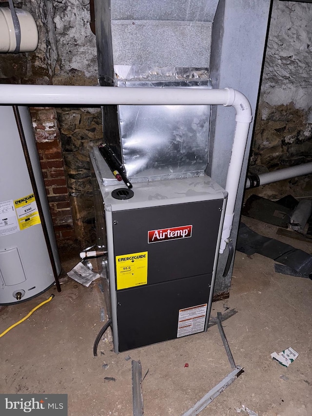 utility room featuring heating unit and water heater