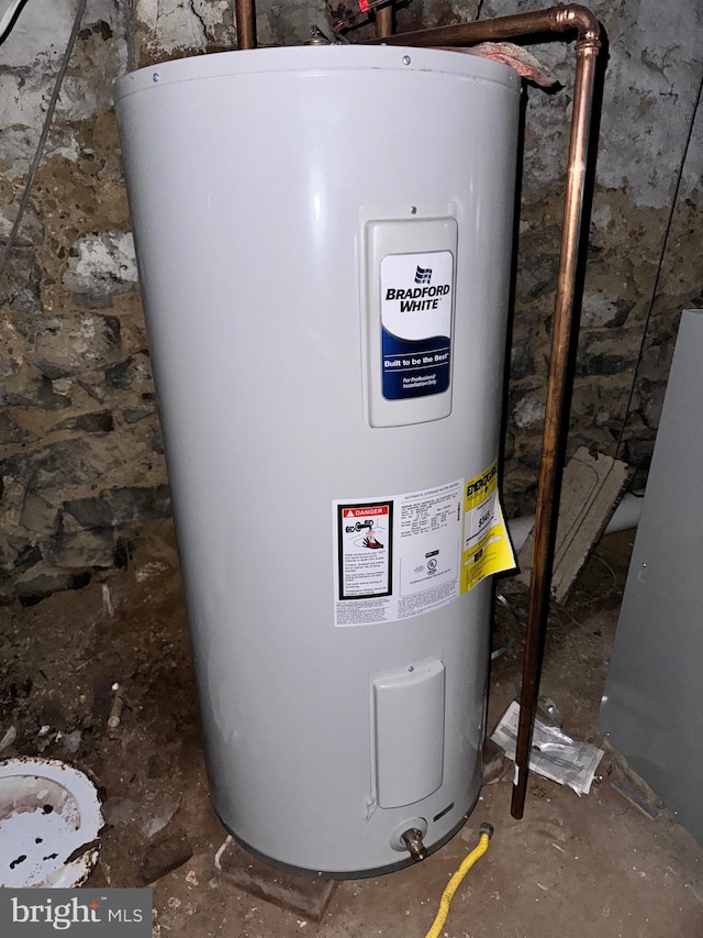 utility room featuring water heater