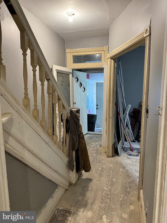 hallway with hardwood / wood-style flooring