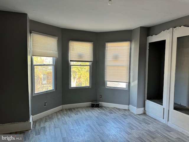 unfurnished room featuring light hardwood / wood-style flooring