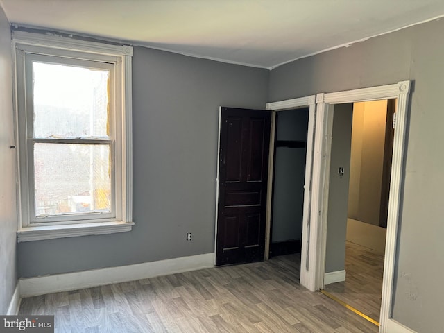 unfurnished bedroom with hardwood / wood-style flooring