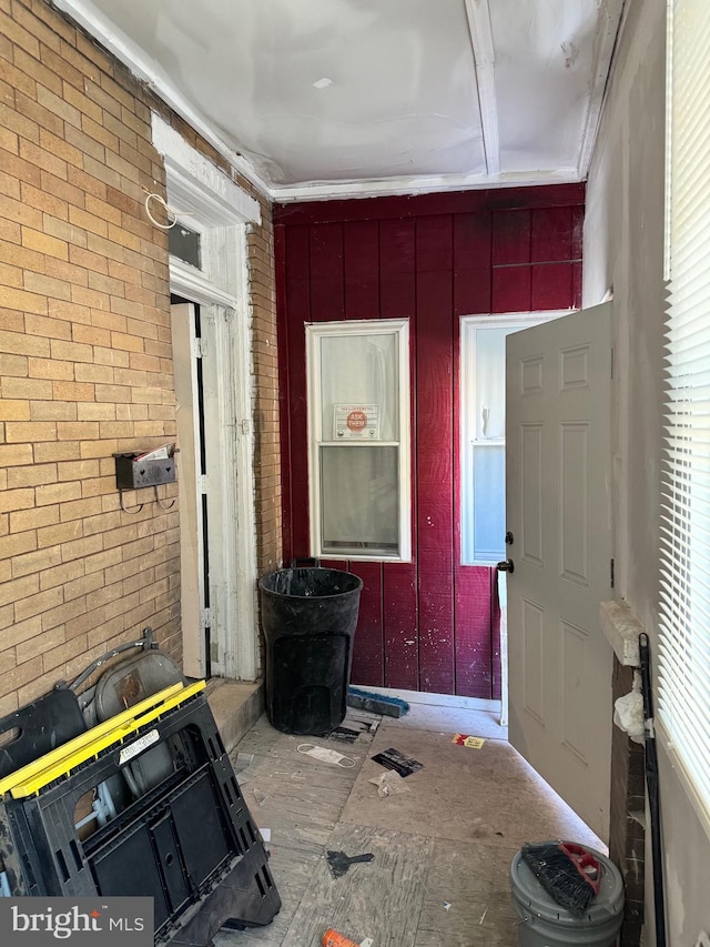 entryway featuring brick wall