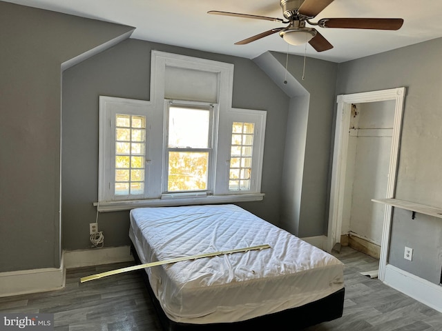 bedroom featuring ceiling fan, vaulted ceiling, and hardwood / wood-style floors