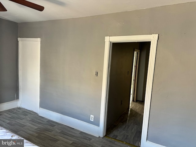 spare room featuring dark wood-type flooring and ceiling fan