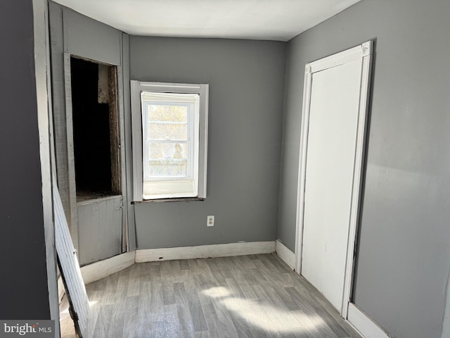 spare room with light wood-type flooring