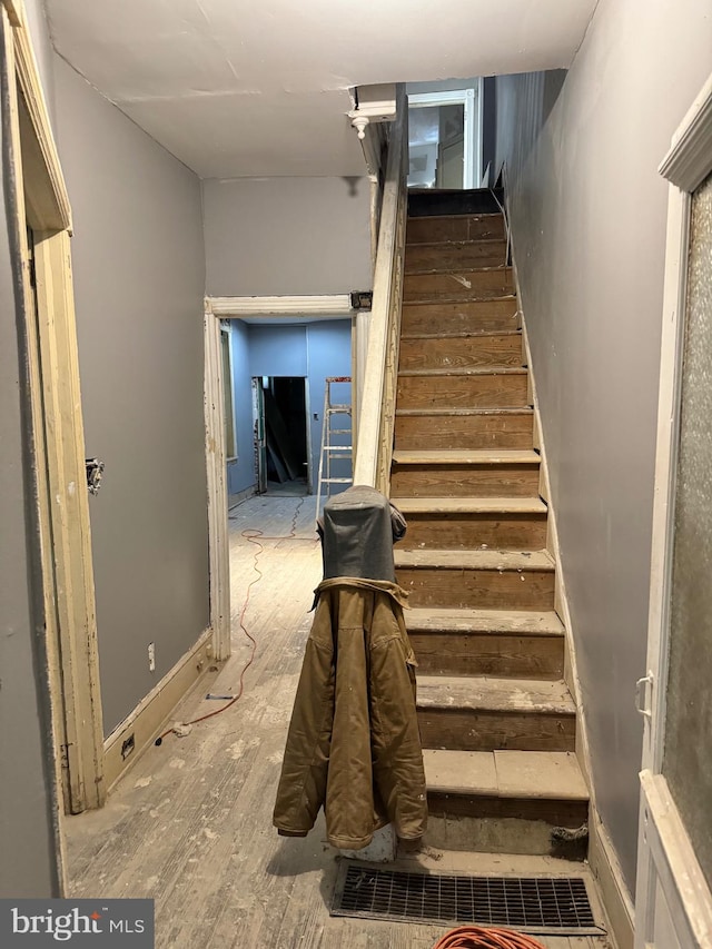 staircase featuring wood-type flooring