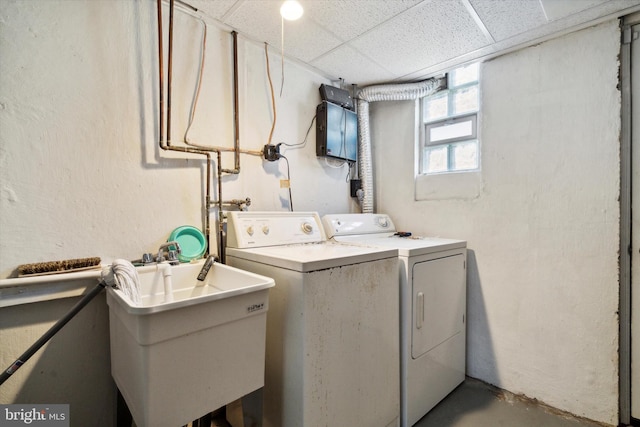 clothes washing area featuring sink and washing machine and clothes dryer