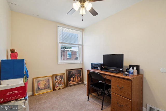 carpeted home office featuring ceiling fan