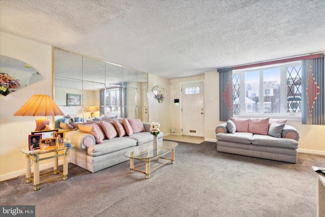 living room featuring dark colored carpet and a textured ceiling