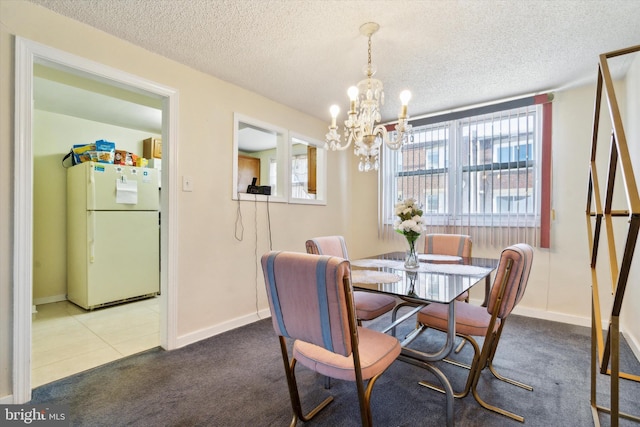 dining space featuring carpet flooring, a textured ceiling, and plenty of natural light