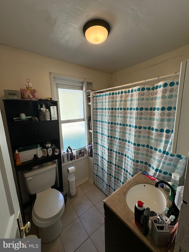 bathroom featuring toilet, tile patterned flooring, and vanity