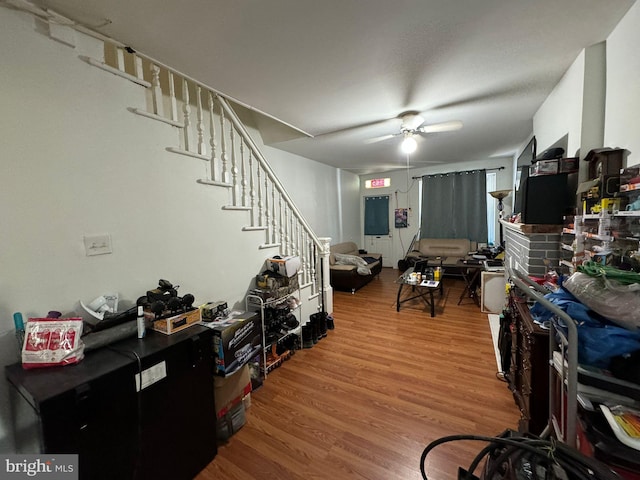 living room with ceiling fan and wood-type flooring