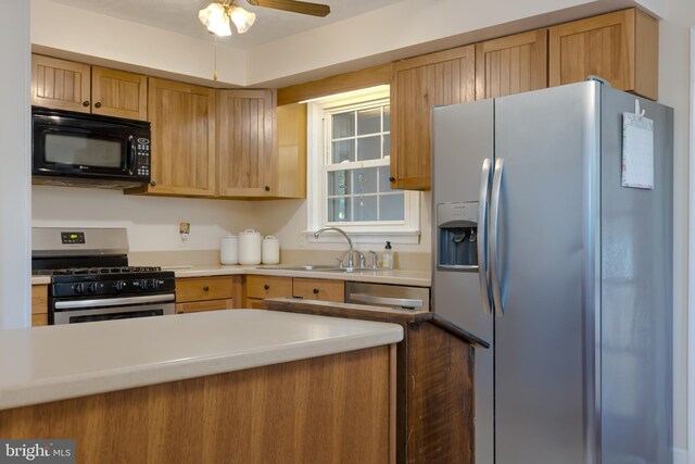 kitchen featuring appliances with stainless steel finishes, sink, and ceiling fan