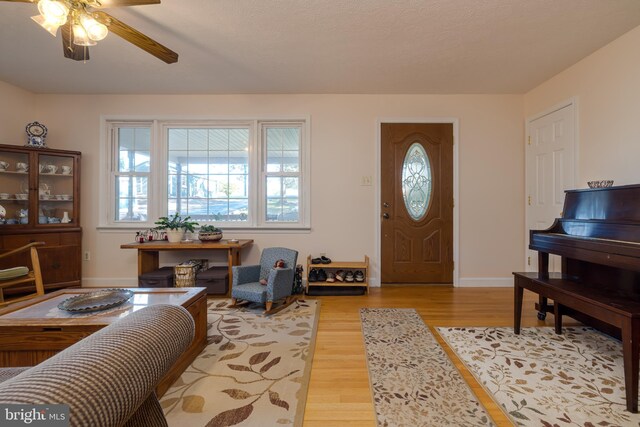 foyer entrance featuring ceiling fan and light hardwood / wood-style floors