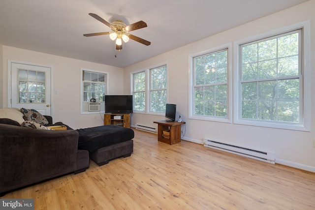 living room with light wood-type flooring, ceiling fan, and a baseboard radiator