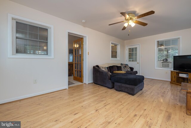 living room featuring light hardwood / wood-style floors and ceiling fan