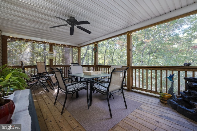 sunroom featuring ceiling fan and plenty of natural light