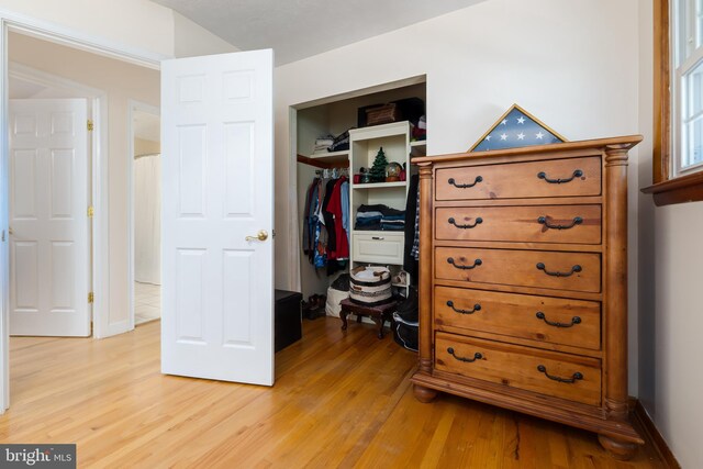 bedroom with a closet and light hardwood / wood-style floors