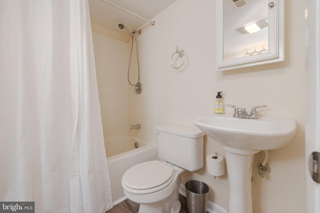 bathroom with shower / bath combo, toilet, and wood-type flooring