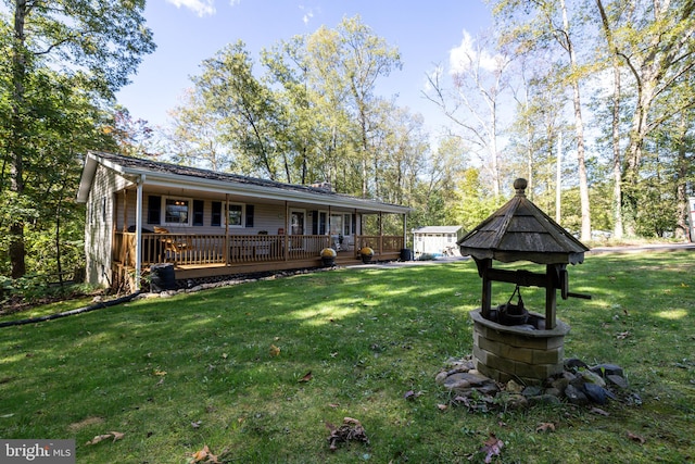 back of property featuring a porch and a lawn