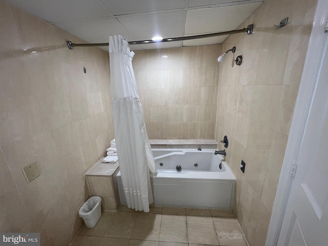 bathroom featuring tile patterned flooring, shower / bathtub combination with curtain, and tile walls