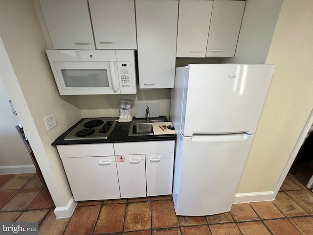 kitchen with white cabinets, sink, and white appliances