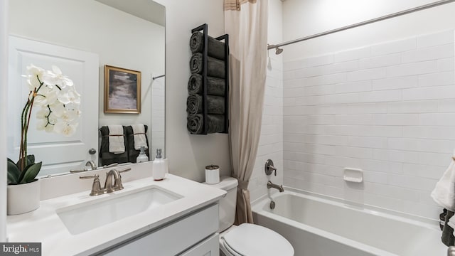 full bathroom with shower / tub combo, toilet, and vanity