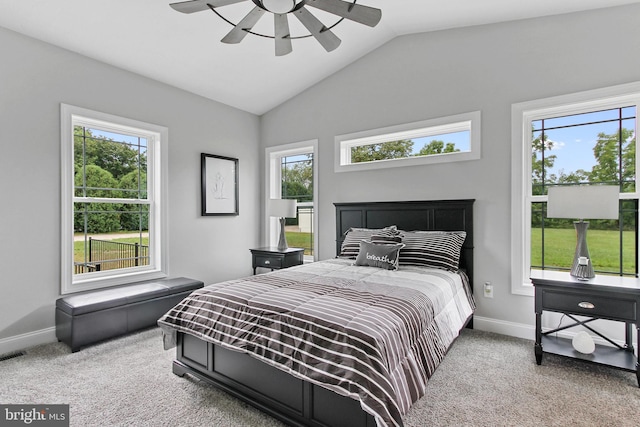 bedroom featuring multiple windows, light colored carpet, and ceiling fan