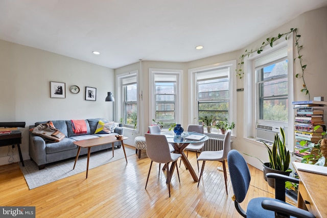 dining room featuring light hardwood / wood-style flooring, cooling unit, and plenty of natural light