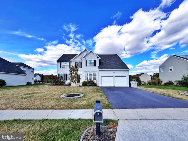 view of front facade featuring a front yard and a garage