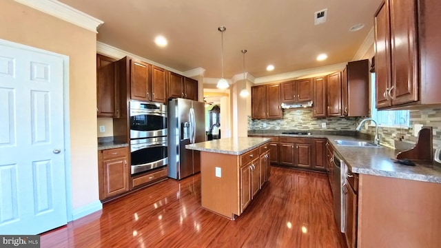 kitchen featuring sink, a center island, dark hardwood / wood-style flooring, stainless steel appliances, and pendant lighting