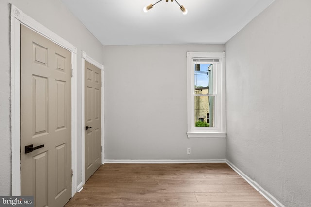 spare room with hardwood / wood-style flooring