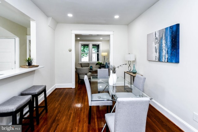 dining area featuring dark wood-type flooring