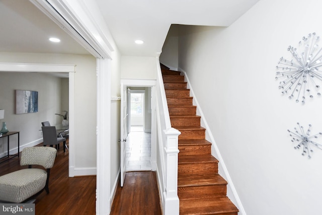 stairs featuring hardwood / wood-style flooring