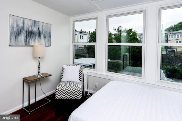 bedroom with dark wood-type flooring