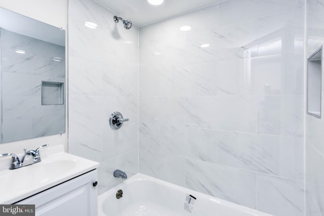 bathroom featuring vanity and tiled shower / bath combo