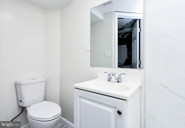 bathroom with toilet and vanity