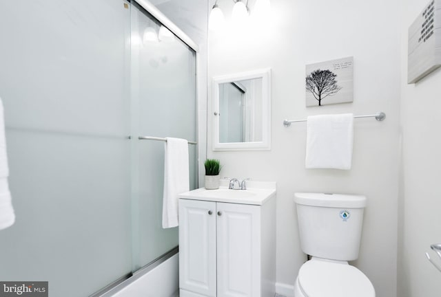 full bathroom featuring bath / shower combo with glass door, vanity, and toilet