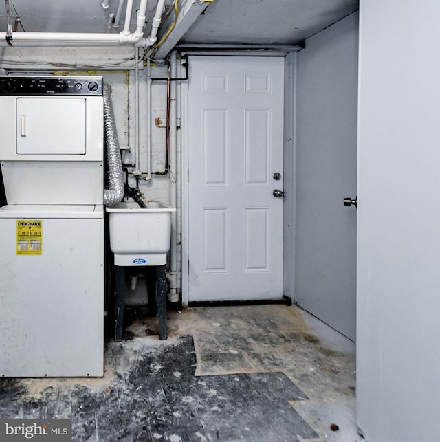 laundry room with stacked washer and clothes dryer and sink