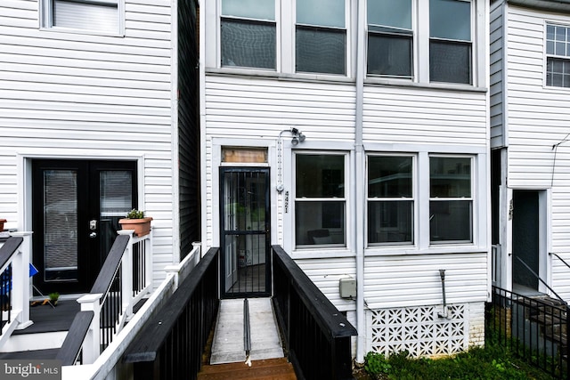 entrance to property featuring a deck and french doors