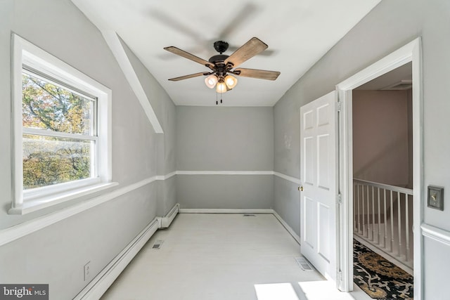 bonus room featuring ceiling fan and a baseboard heating unit